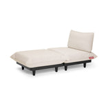 Cream upholstered daybed with plush cushions and backrest on a dark base with rounded legs — Paletti Daybed by Fatboy