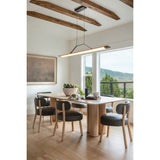 Penna Linear Pendant by Cerno above a dining table beside a window