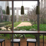 Phobos Ceramic Pendant Light by Geo Contemporary in Military Green, three pendants over a table beside a garden window