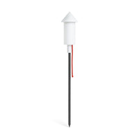 Slim white cone-topped solar lamp on a tall dark ground spike with a red cord — Racket la Surprise Solar Lamp by Fatboy