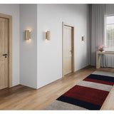 Rima Wall Sconces by Cerno lining a hallway