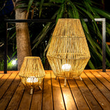 Sisine Floor Lamp - lit on a deck beside the table lamp