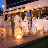 Sisine Floor Lamp - lit at a terrace party