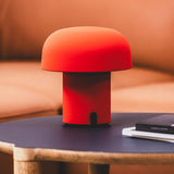 Sensa Battery Table Lamp - Orange, on a side table