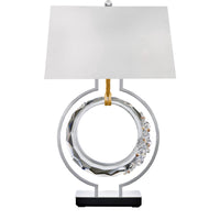 Decorative table lamp with a white shade and metallic base on a white background