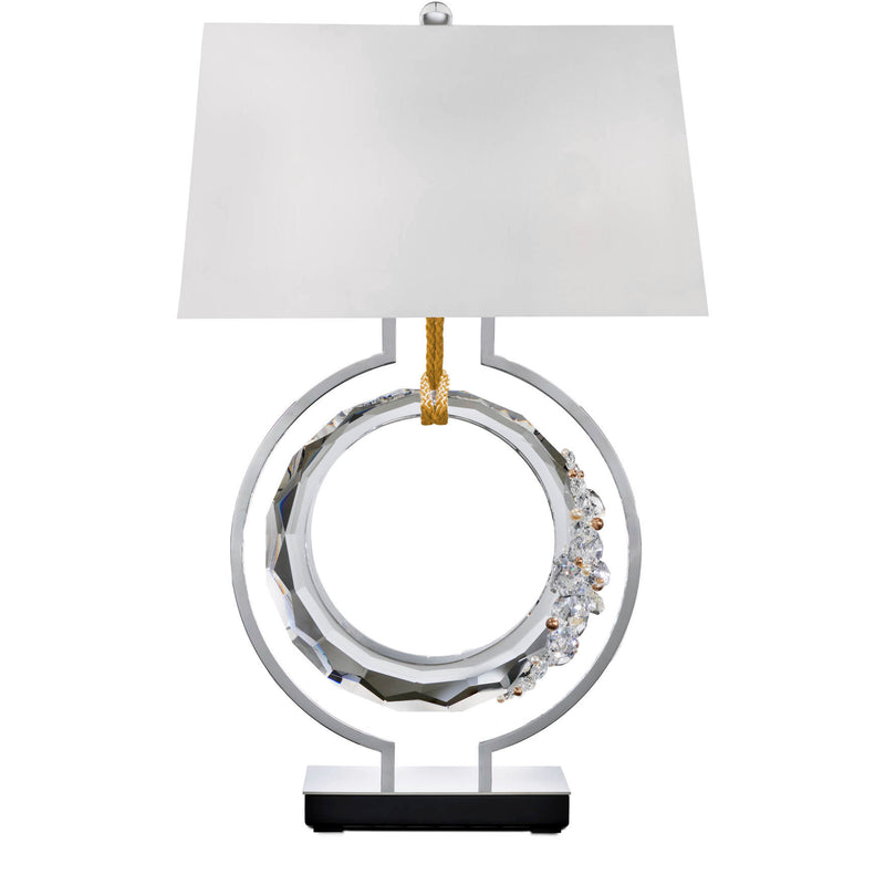 Decorative table lamp with a white shade and metallic base on a white background