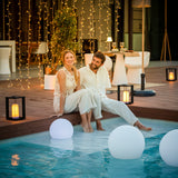Siroco Portable Lantern - on a pool deck at dusk