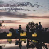 Synergy Battery Wine Cooler Lamp - lit by a pool at dusk