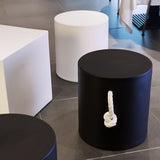 Tafy Side Table - Black, beside a white cube