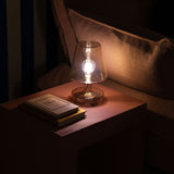 Transloetje Table Lamp - Transparent, lit on a nightstand