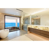 Tempus Wall Sconce by Cerno in a spa bathroom with ocean view