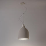 Trento Ceramic Pendant Light by Geo Contemporary in White, lit against a grey studio wall