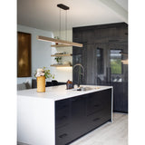 Una Linear Pendant by Cerno in white washed oak over a white kitchen island