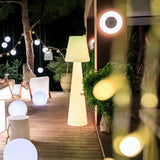 Lola Floor Lamp - 3000K, on a terrace with seating