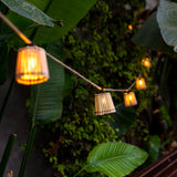 Okinawa Solar String Lights - lit among foliage