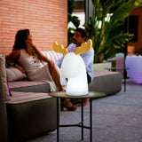 Rudy Reindeer Table Lamp - Solar and Rechargeable, on an outdoor patio