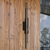 Enzo Outdoor Wall Light by Kuzco - Black, Placed on wood wall