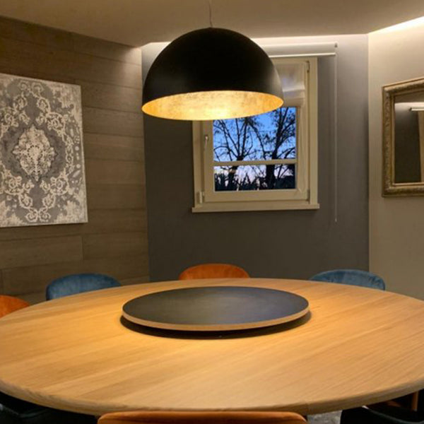 Giove Pendant Light By Egoluc-Black With Gold Leaf Interior Above Table