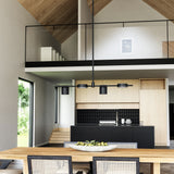Jayden Linear Suspension by Kuzco - Black. Hanging above on the table